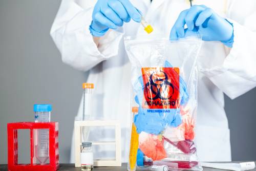 Holding clear poly bag printed with BioHazard